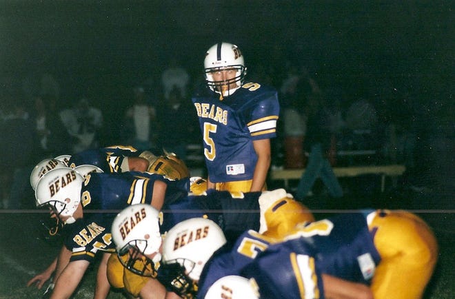 Former Yorkwood quarterback Russell Carlson runs a play for the Golden Bears football team.