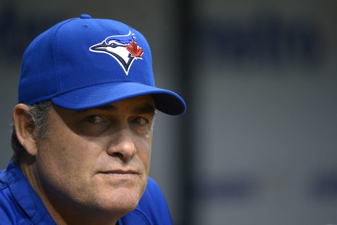 Toronto Blue Jays manager John Farrell watches from the dugout during the first inning of a baseball game against the Tampa Bay Rays in St. Petersburg, Fla., Saturday, Sept. 22, 2012.(AP Photo/Phelan M. Ebenhack)