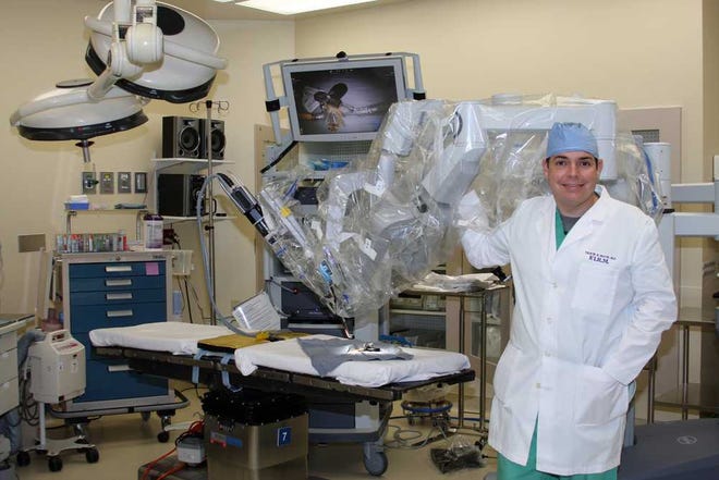 Photos by Maggie.FitzRoy@jacksonville.com Surgeon Travis McCoy stands with the new da Vinci Robotic Surgical System at Baptist Medical Center-Beaches.