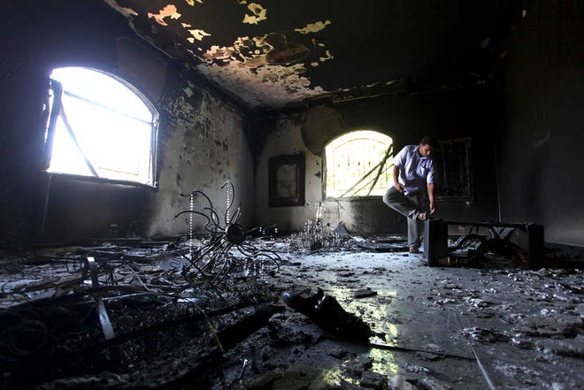 A Libyan man investigates the inside of the U.S. Consulate on Sept. 13 after an attack that killed four Americans, including Ambassador Chris Stevens on Sept. 11 in Benghazi, Libya.