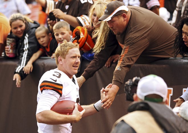 Cleveland Browns quarterback Brandon Weeden celebrates with fans after a 34-24 win over the Cincinnati Bengals in an NFL football game Sunday, Oct. 14, 2012, in Cleveland. Weeden got his first NFL win on his 29th birthday. (AP Photo/Scott R. Galvin)