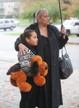 Destiny De'Andrade, 7, Brockton, brought a teddy bear to the funeral of her friend Mary Anne Kotsiopoulos.