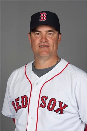 FILE - This 2010, file photo shows Boston Red Sox pitching coach John Farrell. The Red Sox are preparing to announce that John Farrell will be their new manager, according to a baseball official with knowledge of the deal to bring the former Boston pitching coach back one year after the ballclub first tried to give him the top job. The announcement was delayed by the unusual logistics of hiring a manager under contract with another team, the official said, speaking on the condition of anonymity because the final procedural steps had not been cleared. But the three-year deal to replace Bobby Valentine could be announced as soon as Sunday, Oct. 21, 2012 the official said. (AP Photo/Nati Harnik, File)