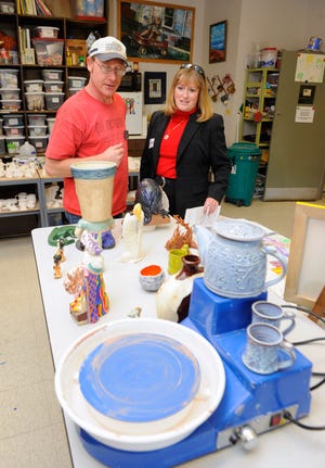 Karsten Ewald, an art instructor for the Columbia Parks and Recreation Adapted Community Recreation Program, explains art projects to Boone County Public Administrator Cathy Richards on Oct. 10 at a Paquin Tower open house. Richards, a Democrat, is running for re-election.
