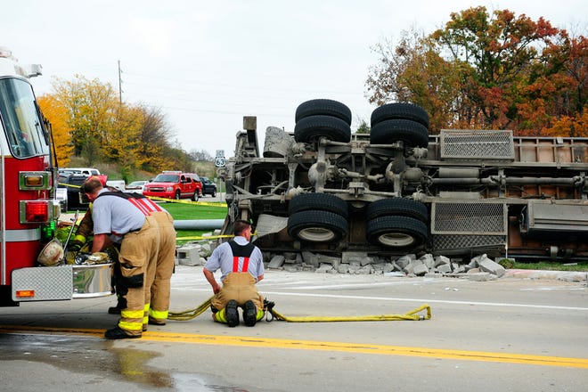 Columbia fire crews work at the scene of a rollover truck crash Monday at Stadium Boulevard and East Pointe Drive.