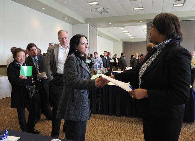 Patricia Ramos of Taunton, left, speaks with Mitchelle Frederick, corporate recruiter for Peabody Properties Inc., during a CareerWorks spring jobs fair in March.