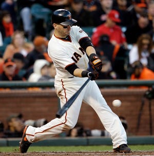 San Francisco Giants' Marco Scutaro hits a single during the fourth inning of Game 6 of baseball's National League championship series against the St. Louis Cardinals Sunday, Oct. 21, 2012, in San Francisco.