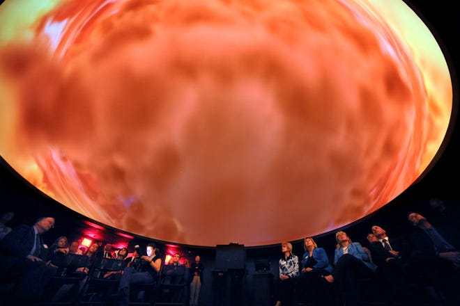 Guests are treated to a show during the grand opening for the new planetarium at the McAuliffe Challenger Center at Framingham State University.
