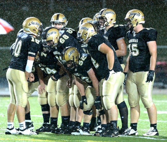 The St. Thomas Aquinas offense huddles up prior to a play against Northwest on Oct. 19, 2012.