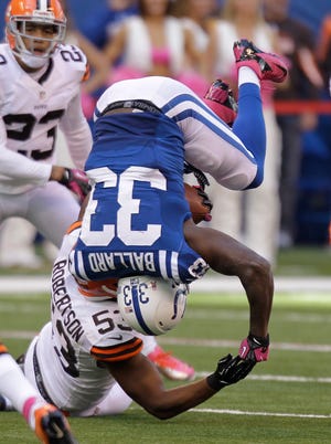 Indianapolis Colts' Vick Ballard (33) is upended by Cleveland Browns' Craig Robertson (53).