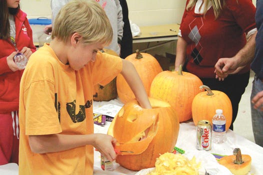 J.K.L. Bahweting School in Sault Ste. Marie hosted a fun Halloween activity for students and their families on Tuesday evening. After selecting the perfect pumpkin, kids were able to carve and decorate it for the upcoming holiday. Here, Dylan Malmborg, age 11, works on taking out the mouth portion he’d carved out of his jack-o-lantern.