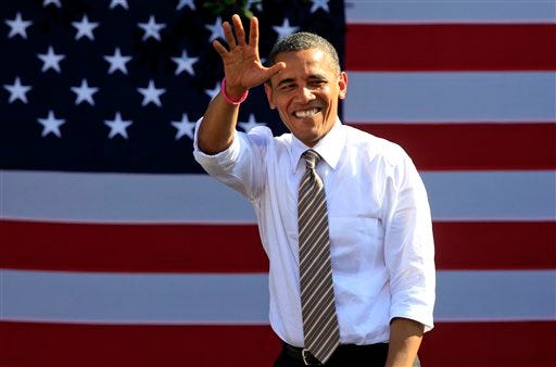 President Barack Obama waves to supporters during a campaign rally in Byrd Park in Richmond, Va., on Thursday. The president is on the second day of his 48 hour, 8 State campaign blitz.