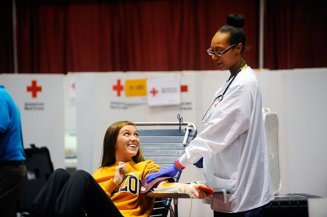 University of Missouri Columbia freshman Erin Barnicle smiles at American Red Cross charge nurse Tiara Gilkey as Barnicle gives blood on Oct. 15 at the 27th annual Homecoming Blood Drive.