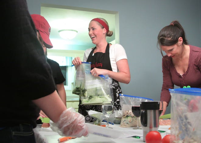Mandy Keith, 33, center, runs Yummy Mummy Meals Workshop out of her Hanover home. She helps busy mothers prepare ready-to-heat freezer meals – from chili to pork chops – with an emphasis on nutrition.