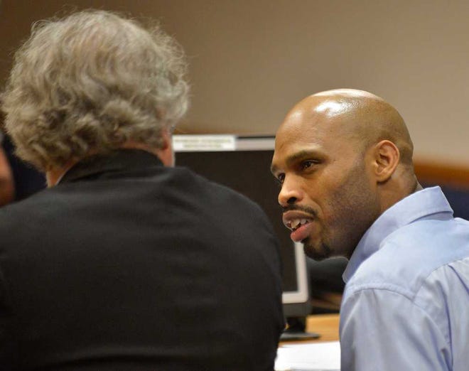 Accused cop killer Jamie Hood, right, talks with his attorney, Newell M. Hamilton Jr., in Superior Court Judge David Sweat's courtroom during court at the Clarke County Courthouse on Friday, Oct. 26, 2012.  Richard Hamm/Staff