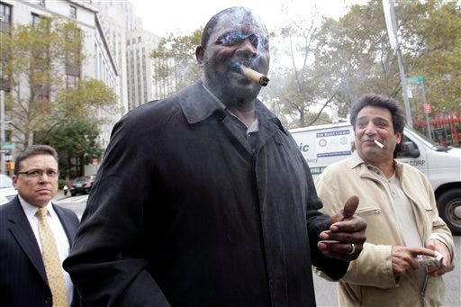 Former New York Giants linebacker Lawrence Taylor smokes a cigar as he leaves federal court on Friday in New York. Taylor won a lawsuit that tried to hold him accountable for having sex with a 16-year-old girl in a New York-area hotel room. The NFL Hall of Famer acknowledged that he had sex in 2010 with a prostitute. He denied, however, that he ignored obvious signs she was a teen runaway in distress.