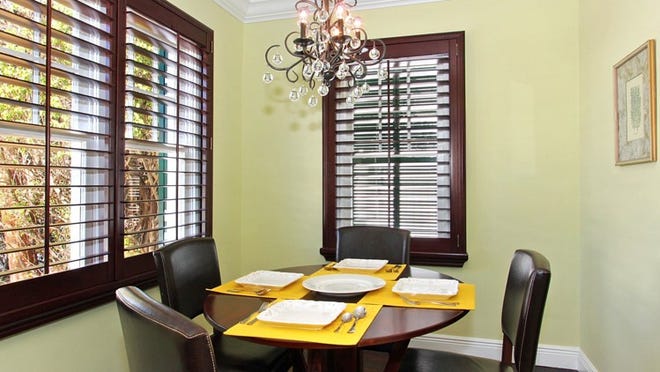As in the dining room, plantation shutters have been installed throughout the house, their dark stain echoing the look of the hardwood floors.