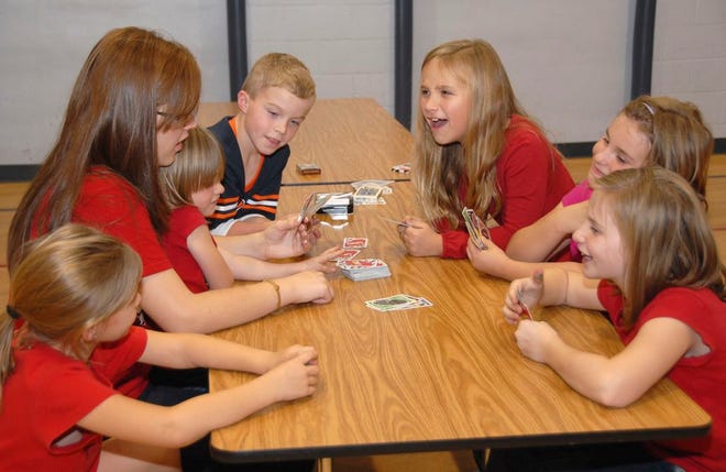 At the card game station, young students and their siblings gathered around St. Mary Elementary School Student Council President Aubrey Gill for a lively game of Uno during the Student Council’s babysitting service project going on during Parent Teacher Conferences on Wednesday and Thursday.