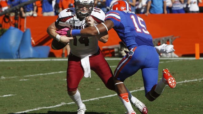 Florida defensive back Loucheiz Purifoy (15) causes South Carolina quarterback Connor Shaw (14) to fumble on the first play from scrimmage in the first quarter at Ben Hill Griffin Stadium in Gainesville, Florida, on Saturday, Ocotber 20, 2012. (Gerry Melendez/The State/MCT)