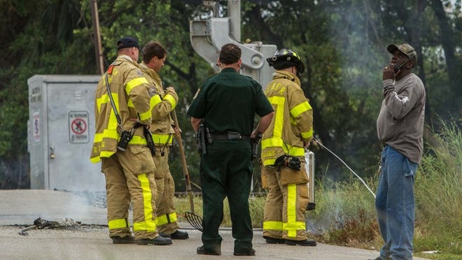 20121025 (Thomas Cordy/The Palm Beach Post)—-LAKE WORTH—West Palm Beach Fire Rescue responded to a small brush fire caused by a downed electrical line in Lake Worth today, Thursday, October 25, 2012. The power line fell near the railroad crossing at 22nd Ave North in Lake Worth. Power is still out in much of the north end of the city. Lake Worth Utilities workers are working to correct the outage.