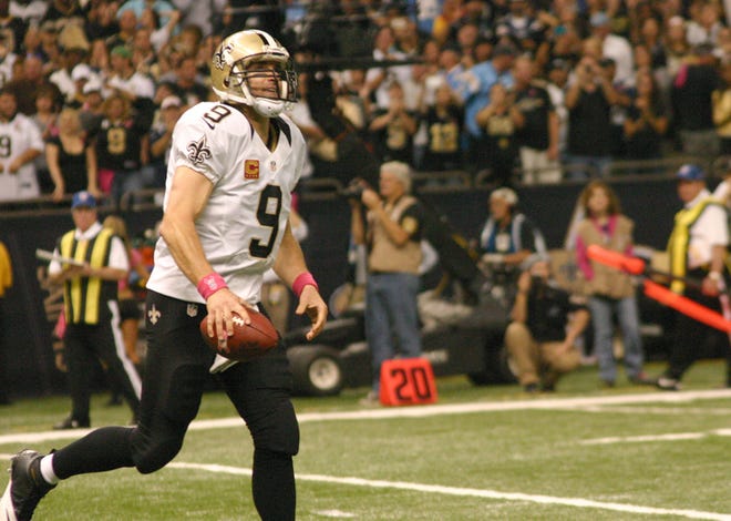 New Orleans Saints quarterback Drew Brees displays the ball that he broke Johnny Unitas' record for most consecutive games with a touchdown pass against the San Diego Chargers earlier in the season. Brees threw for 377 yards and four touchdowns in the Saints' 35-28 victory over Tampa Bay on Sunday. 
POST SOUTH PHOTO/Peter Silas Pasqua