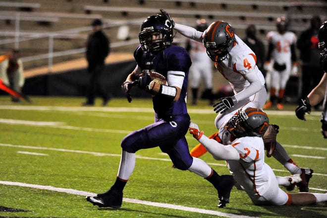 JEFF HEIMSATH / AMARILLO GLOBE-NEWS  Canyon running back Walker Horn scores the first touchdown of the game as he breaks away from Caprock defenders Friday night. Canyon won, 34-7.