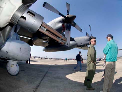 Staff Sgt. Corey Babcock, left, talks with Cliff Withers next to an AC-130U gunship during Saturday's open house at Hurlburt Field.