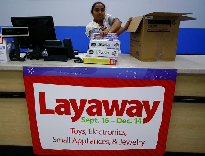 The holiday "layaway" is back at Walmart. In Quincy Poonam Patel boxes electronics a customer put on layaway until Dec. 14. Thursday Oct. 25, 2012.Greg Derr/The Patriot Ledger 2012BIZ Photo