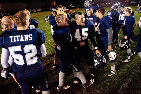 Monmouth-Roseville players celebrate after defeating St. Bede Academy in their opening playoff game Saturday night.
