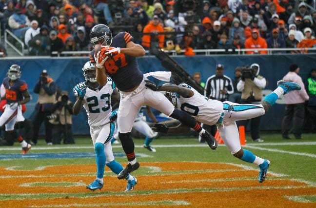 Chicago Bears tight end Kellen Davis (87) makes a catch for touchdown over Carolina Panthers safeties Charles Godfrey, right, and Sherrod Martin (23) during the second half of an NFL football game in Chicago on Sunday. The Bears won 23-22.