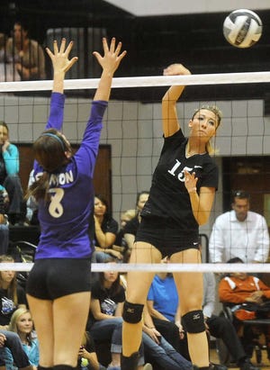 Randall's Kaetlyn Weatherford, right, spikes the ball past Canyon's Mackenzie Clarke during a game this season.