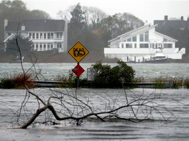 A downed limb lies in a flooded street as Hurricane Sandy approaches Monday in Center Moriches, N.Y.