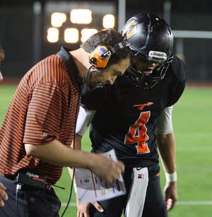 Wayland quaretrback Matthew Goddard (right), shown talking with offensive coordinator Joe Cincotta during a recent game, had a big night in the Warriors' win over Newton South on Friday as the team gets ready for a couple of big DCL Small showdowns.