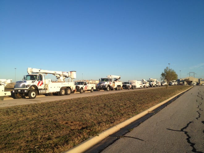 A line of Xcel Energy trucks from Amarillo gets ready to depart for Wytheville, Va., on Wednesday. Xcel is sending more than 30 employees to help restore electricity to the area ravaged by superstorm Sandy.