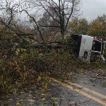 Heavy fallen tree limbs during Hurricane Sandy overturned a utility truck on Station Road in Richland.