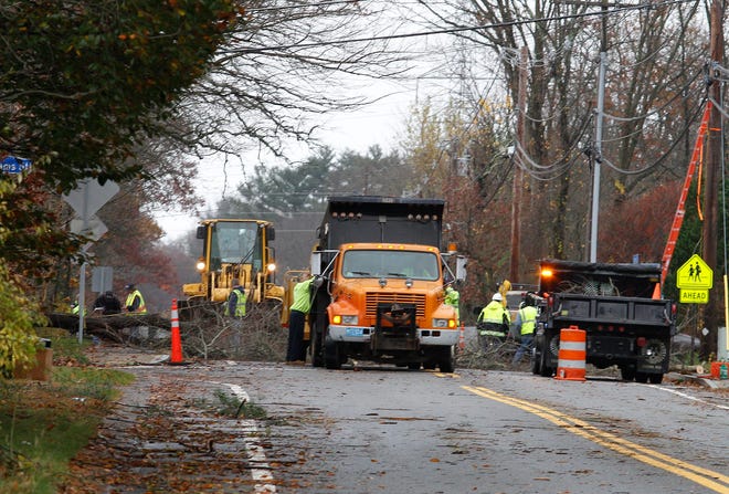 Workers have to clear out a tree that fell near the corner of Adams Street and Rte. 126 in Medway some time Wednesday morning.