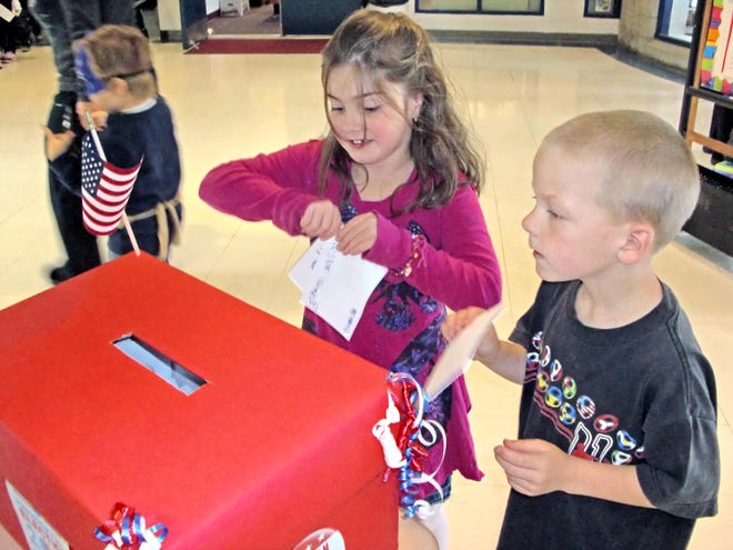 Second graders Nadia DaSilveira and Scott Lynch cast their ballots at the Berkley Community School mock election on Wednesday.