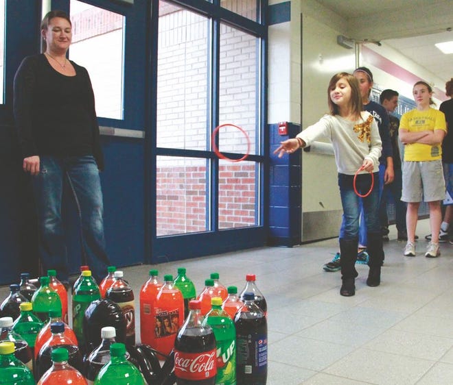 Kylee Pavlat, 7, participated in Family Fun Night activities on Thursday, attempting to place a ring around an octopus surrounded by pop. The event, held at the Sault Area Middle School, serves as a fundraiser for the Parent Teacher Organization.