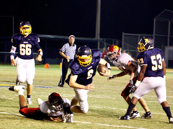 Tuscaloosa Academy quarterback Jonathan Plott (9) is taken down by Escambia Academy’s Winston Barron (45) during the first quarter of an AISA Class AAA first-round playoff game. The Knights won, 28-8.