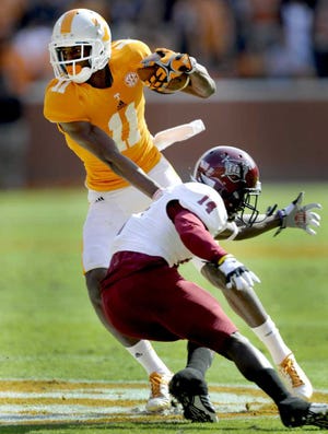 Michael Patrick Knoxville News Sentinel  Tennessee wide receiver Justin Hunter (11) dodges Troy defensive back Zach Miller during the first half on Saturday in Knoxville, Tenn.