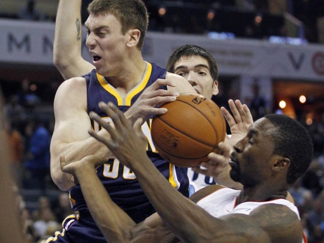 Indiana Pacers' Tyler Hansbrough, left, and Charlotte Bobcats' Ben Gordon, right, wrestle for control of a rebound during the first half of an NBA basketball game in Charlotte, N.C., Friday, Nov. 2, 2012.