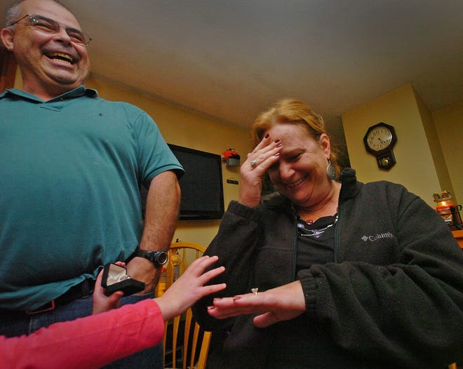 Valerie Lynch, 47, is overcome with emotion after getting back a diamond ring she lost 15 years ago from Kent Blethen, left, a family friend who found the ring last weekend outside the home of Lynch's sister in Plymouth, Friday, Nov. 2, 2012. Lynch was originally given the 1.2-carat diamond ring by her husband Mike Lynch 20 years ago. The arm of Valerie's niece Chloe Nichols, 5, extends into the picture.Photo: Amelia Kunhardt/The Patriot Ledger