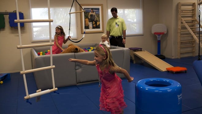 2012-11-3 (Brynn Anderson/The Palm Beach Post) - Palm Beach Gardens - During the opening of Miami Children’s Hospital Nicklaus Outpatient Center, sisters Nicole, 7, front, and Taylor, 4, left, Nicklaus, patient Tanner Adams, 2, and Jeremy Perivee break in the new open activities gym on Saturday, Oct. 3, 2012. The center is the second MCH pediatric care facility in Palm Beach County to be created for families that don’t want to travel for outpatient care.
