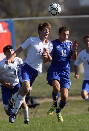 Washburn Rural's Corey Hall, right, and Wichita Northwest's Jake Carter collide during Saturday's Class 6A state title game in Olathe. Hall scored the first goal in the Junior Blues' 2-0 victory
