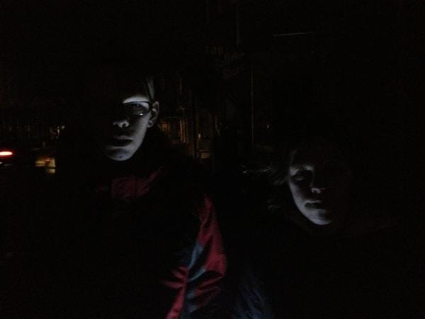 David Wallace, 14, and his sister, Courtney, 16, are illuminated by a small flashlight as they stop to chat Mill Street in Bristol Borough during the blackout in the wake of super storm Sandy, Oct. 30, 2012.