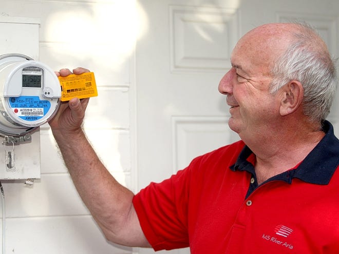 Fred Gruner looks at the radiation-detection card he placed by his electric smart meter at his home in Ormond Beach in this October 23, 2012, photo.