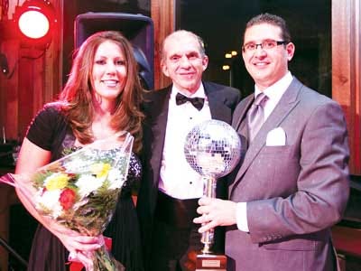Photo by Amy Herzog/New Jersey Herald - Sarah Roskowski, left, and Vito Giannola, right, both of Sussex Bank, pose with dance instructor David Cross as they hold their first-place trophy at the “Dance with the Stars" gala.