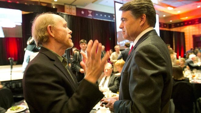 Gov. Rick Perry, right, chats with filmmaker Ron Howard on Thursday, Nov. 1, 2012, during a luncheon that served as the official kickoff for the U.S. Grand Prix, which will run at Circuit of The Americas from Nov. 16-18. Next year, Howard will release a film titled “Rush” that chronicles the F1 rivalry between iconic drivers Niki Lauda and James Hunt.