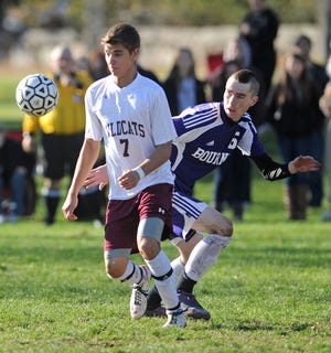 West Bridgewater High School's Reed Crowley knocks down the ball ahead of Bourne High School's Matthew Moriarty during the boys varsity soccer game in West Bridgewater on Sunday, November 4, 2012.
