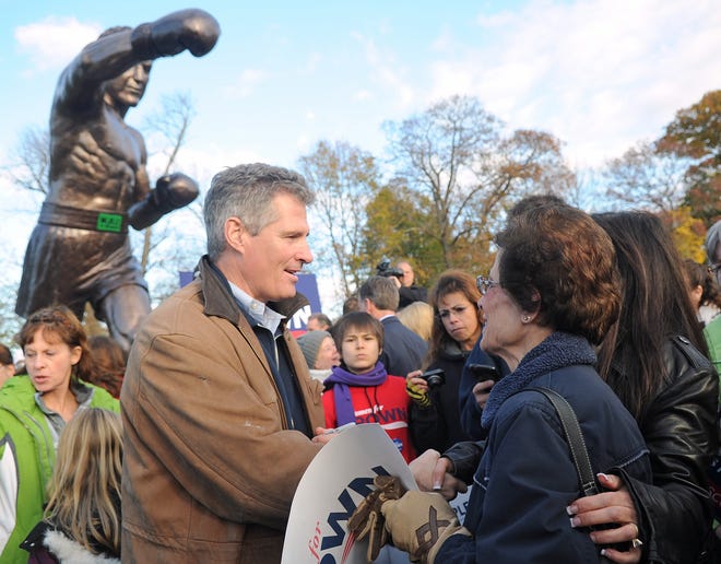 U.S. Senator Scott Brown shakes hands and signs autographs for supporters gathered at the base of the Rocky statue in Marciano Stadium in Brockton on Sunday, November 4, 2012.